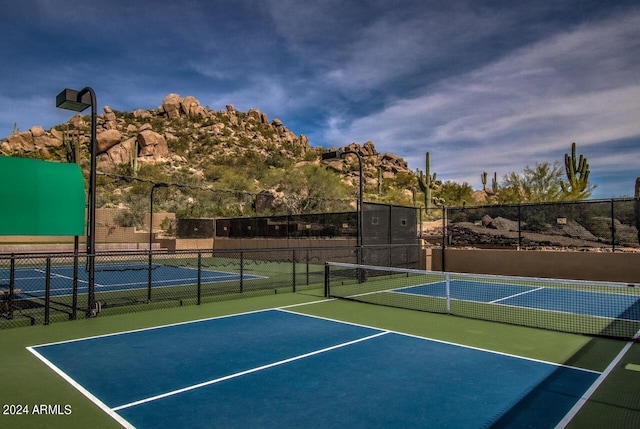 view of sport court with basketball hoop