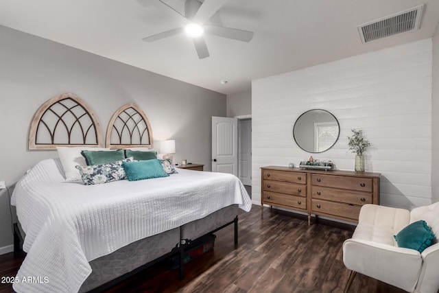 bedroom with a ceiling fan, visible vents, and wood finished floors