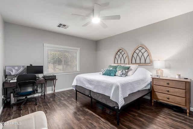 bedroom with ceiling fan, wood finished floors, visible vents, and baseboards