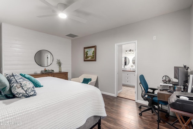 bedroom featuring visible vents, a ceiling fan, connected bathroom, wood finished floors, and baseboards