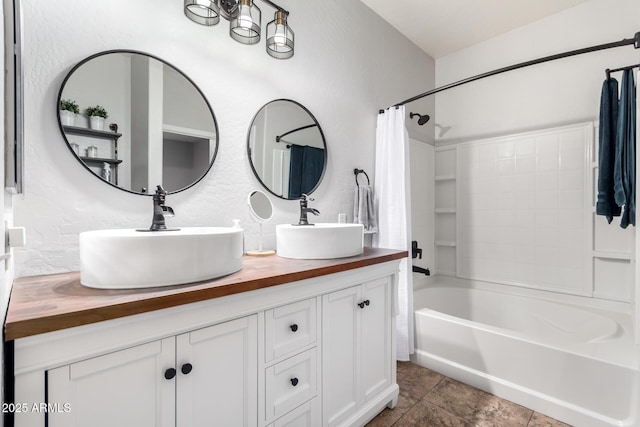 bathroom with double vanity, tile patterned flooring, a sink, and shower / bath combo with shower curtain