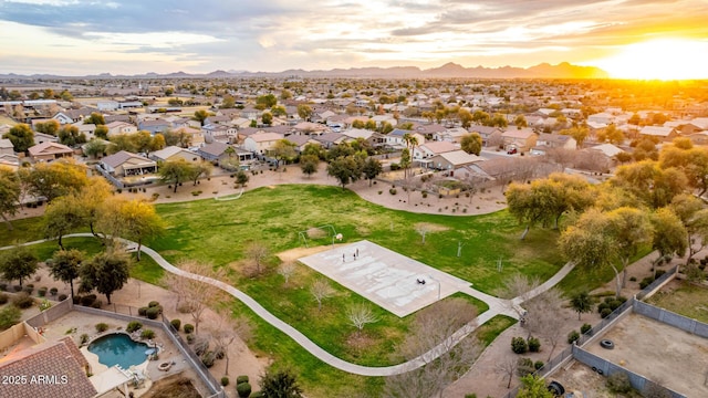 aerial view at dusk featuring a residential view and a mountain view