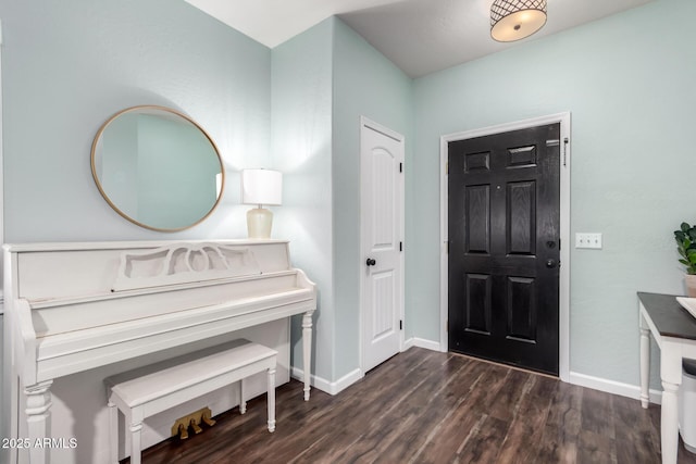 foyer with dark wood-style floors and baseboards