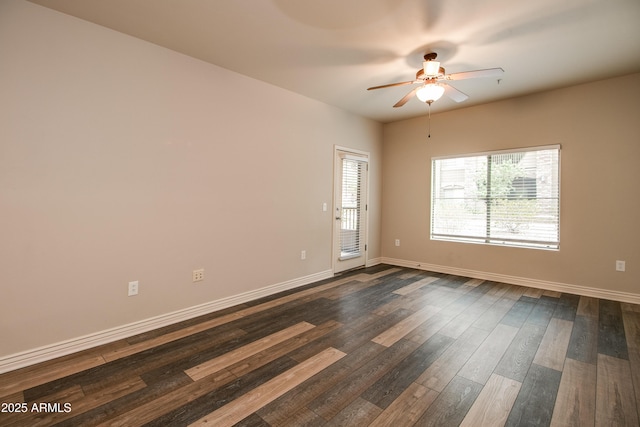 spare room with ceiling fan and dark hardwood / wood-style floors