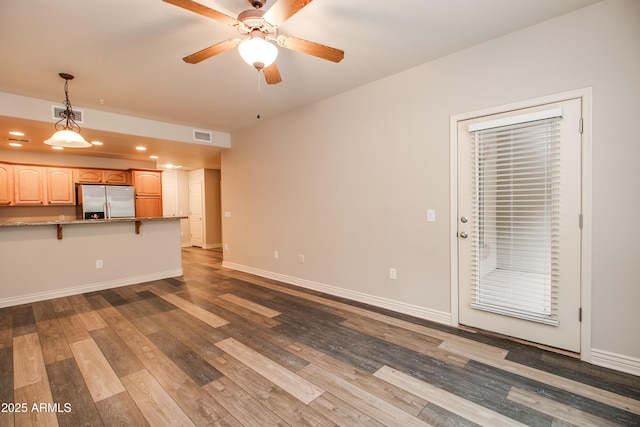 unfurnished living room with hardwood / wood-style flooring and ceiling fan