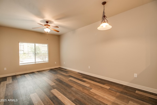 empty room featuring ceiling fan and dark hardwood / wood-style floors