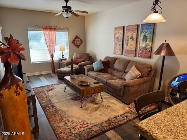 living room featuring ceiling fan and wood-type flooring