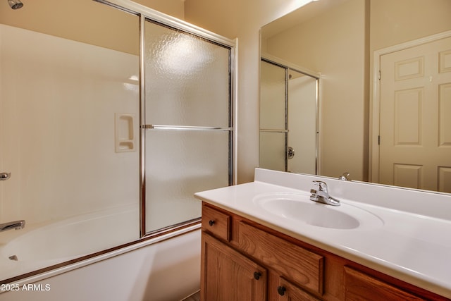 bathroom with vanity and shower / bath combination with glass door