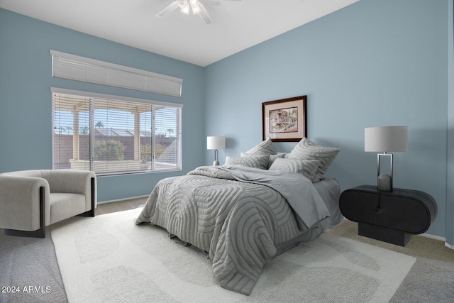 bedroom with ceiling fan and light colored carpet