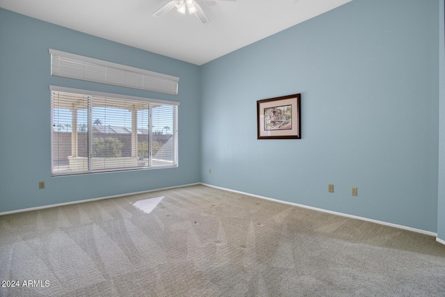 empty room with ceiling fan and light colored carpet