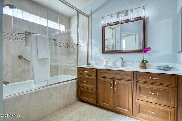 bathroom featuring shower / bath combination with glass door and vanity