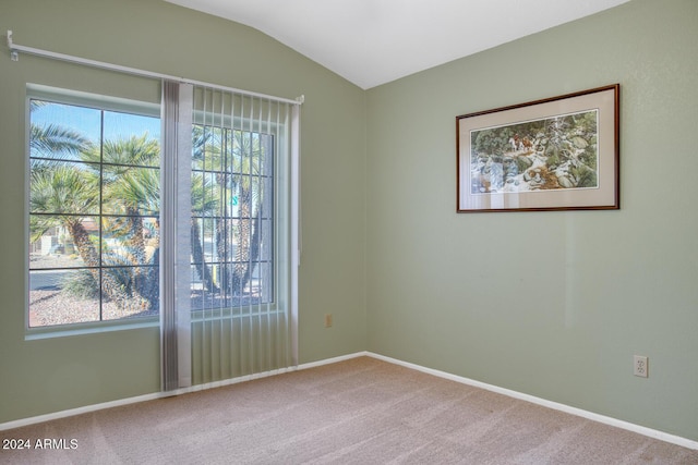 unfurnished room featuring carpet floors and vaulted ceiling