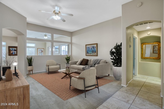 living room with ceiling fan and light tile patterned flooring