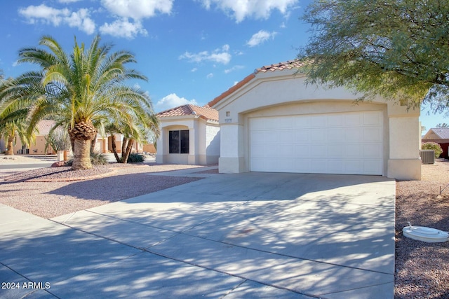 mediterranean / spanish house featuring central AC and a garage