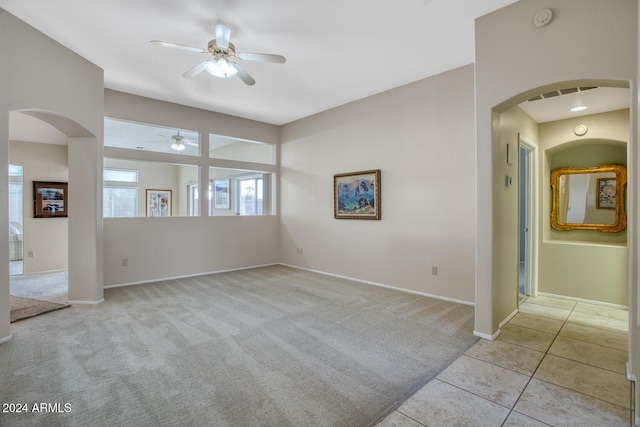 unfurnished room featuring ceiling fan and light tile patterned floors