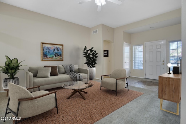 living room with light carpet and ceiling fan