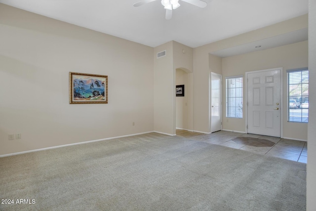 carpeted entrance foyer with ceiling fan