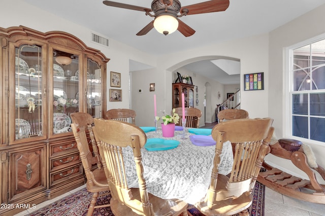 tiled dining space featuring ceiling fan