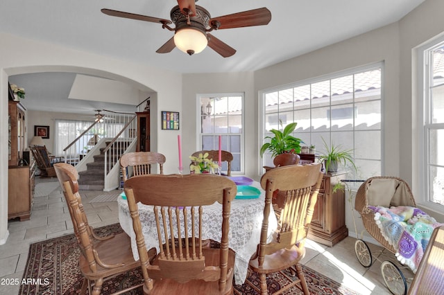 tiled dining area with ceiling fan