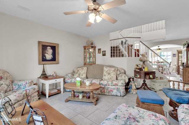 living room featuring light tile patterned floors and ceiling fan