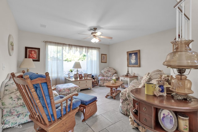 living area with ceiling fan and light tile patterned floors