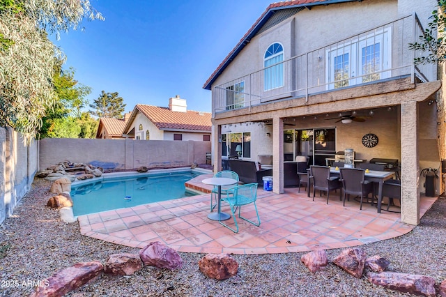 view of swimming pool with a patio area, ceiling fan, and an outdoor hangout area