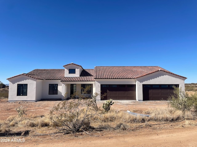 mediterranean / spanish-style home featuring a garage