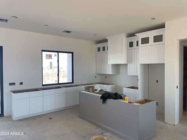 kitchen featuring a kitchen island and white cabinets