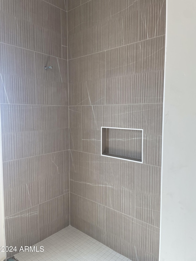 bathroom with a tile shower