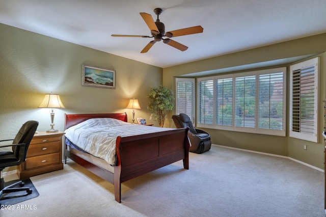 bedroom with light carpet and ceiling fan