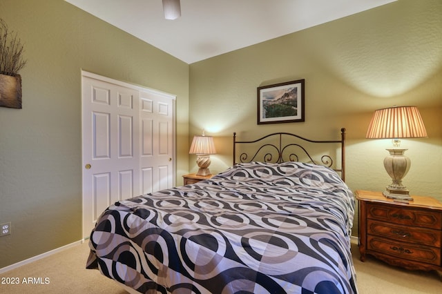 bedroom with a closet and light colored carpet