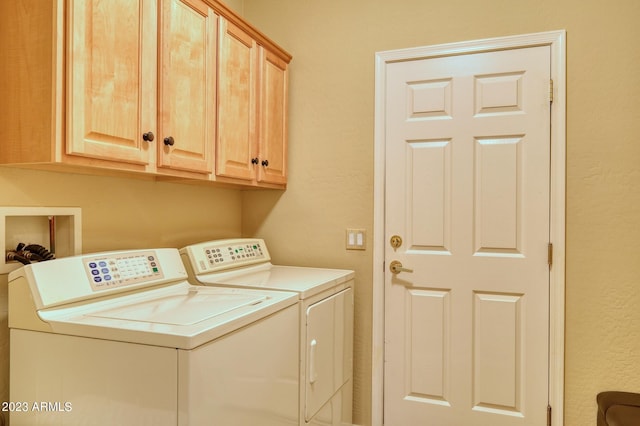 laundry room featuring hookup for a washing machine, washer and clothes dryer, and cabinets