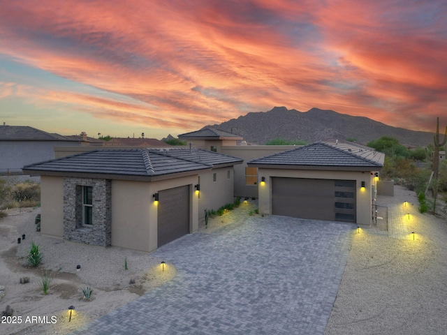 prairie-style house featuring a mountain view and a garage