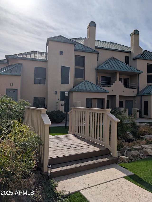 back of property featuring a wooden deck