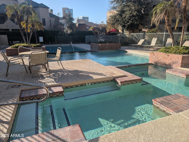 view of pool featuring an in ground hot tub and a patio