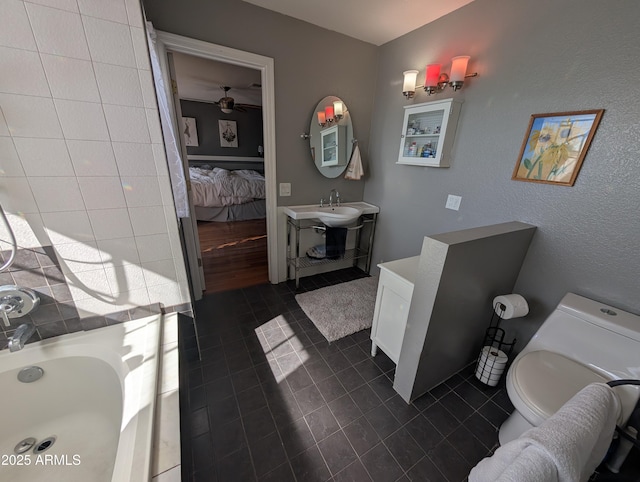 bathroom with vanity, toilet, tile patterned flooring, and a washtub