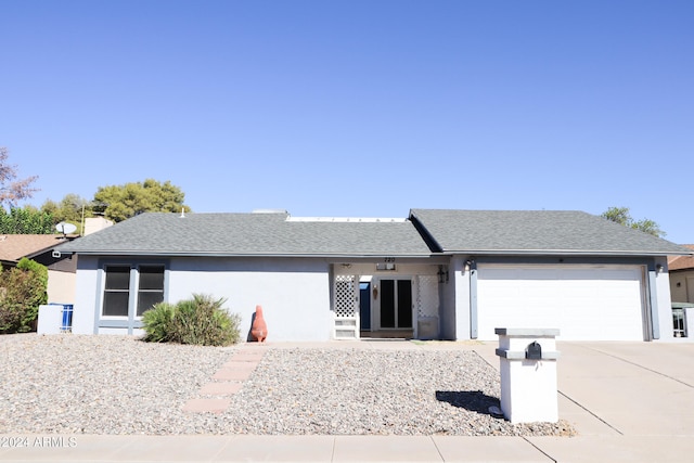 ranch-style home featuring a garage