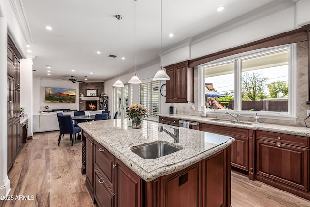 kitchen with open floor plan, ceiling fan, a sink, and decorative backsplash