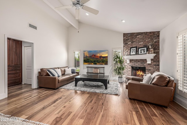 living room featuring light wood finished floors, visible vents, and plenty of natural light