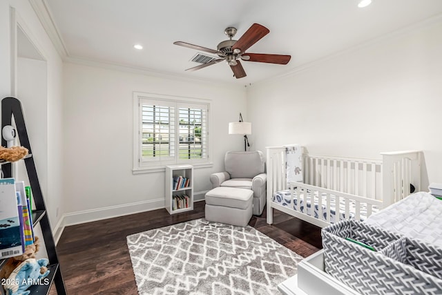 bedroom with baseboards, ornamental molding, and wood finished floors