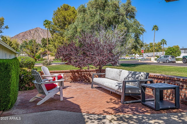 view of patio featuring outdoor lounge area and a mountain view