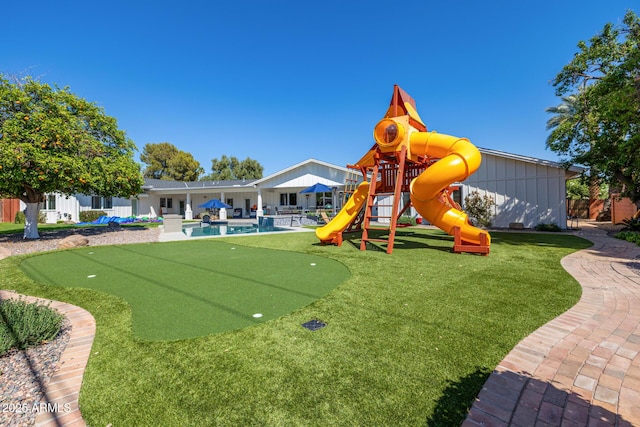 view of play area with an outdoor pool, a patio, fence, and a lawn