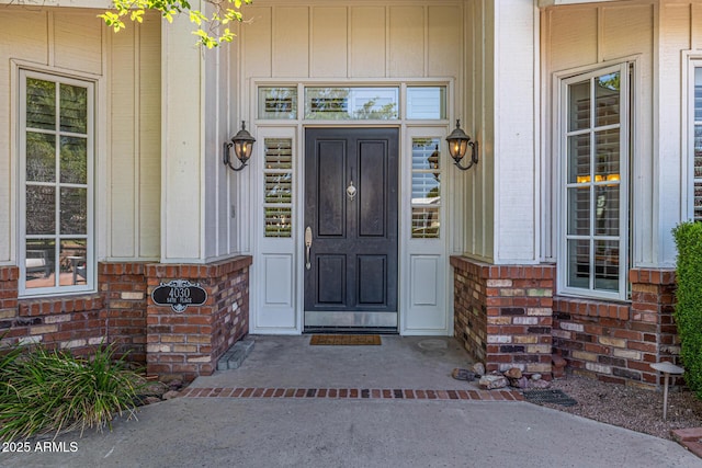 view of exterior entry with brick siding