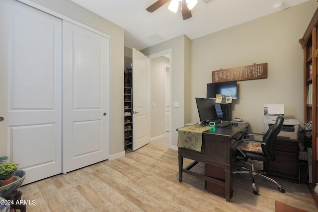 office area featuring light wood finished floors, a ceiling fan, and baseboards