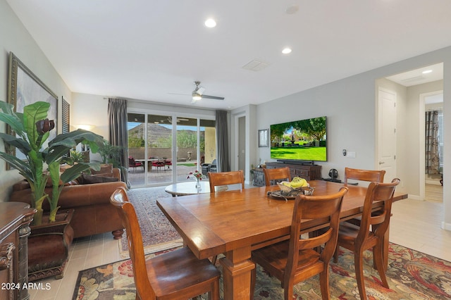 dining room with baseboards, light wood-style floors, a ceiling fan, and recessed lighting