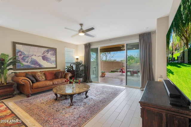 living room featuring light wood-type flooring and ceiling fan