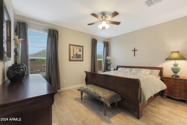 bedroom featuring multiple windows, light wood-type flooring, and visible vents