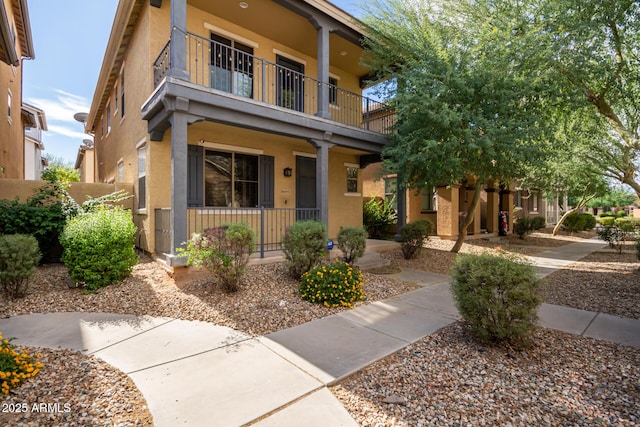 view of front of house featuring a balcony and a porch