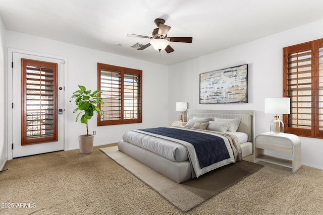 carpeted bedroom with ceiling fan and access to outside