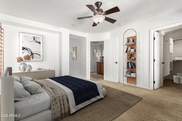 carpeted bedroom with connected bathroom and ceiling fan